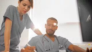  A nurse and a doctor collaborating on a computer