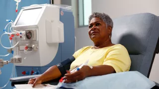 A women in a hospital receving HDx therapy enabled by Theranova and an AK 98 system