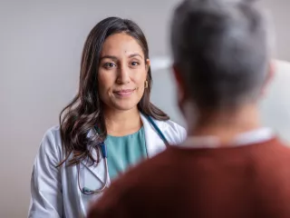  A female doctor attentively conversing with a patient, providing medical care and support