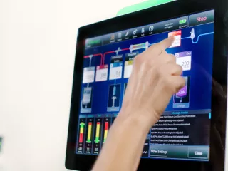Someone interacting with the PrisMax touch screen