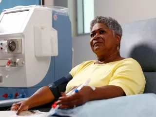 A women in a hospital receving HDx therapy enabled by Theranova and an AK 98 system